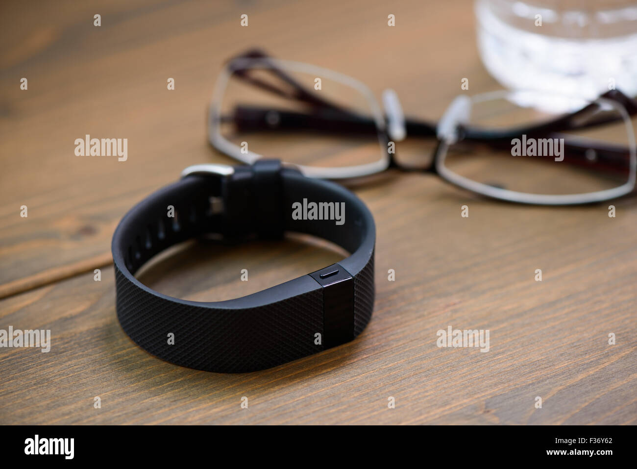wearable device, wirst watch type Sports tracker and other objects on a wooden board Stock Photo