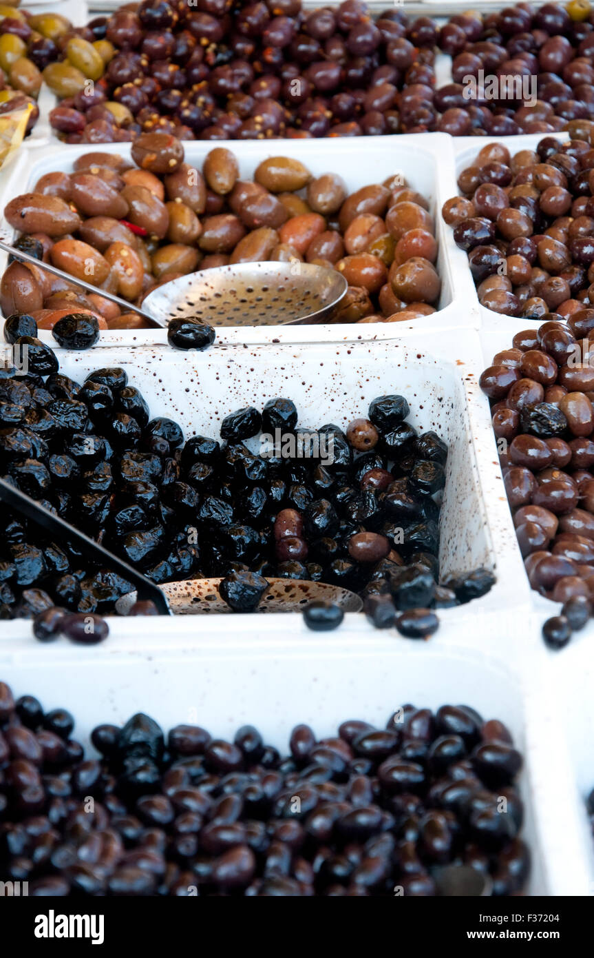 Container containing olives of various colors Stock Photo