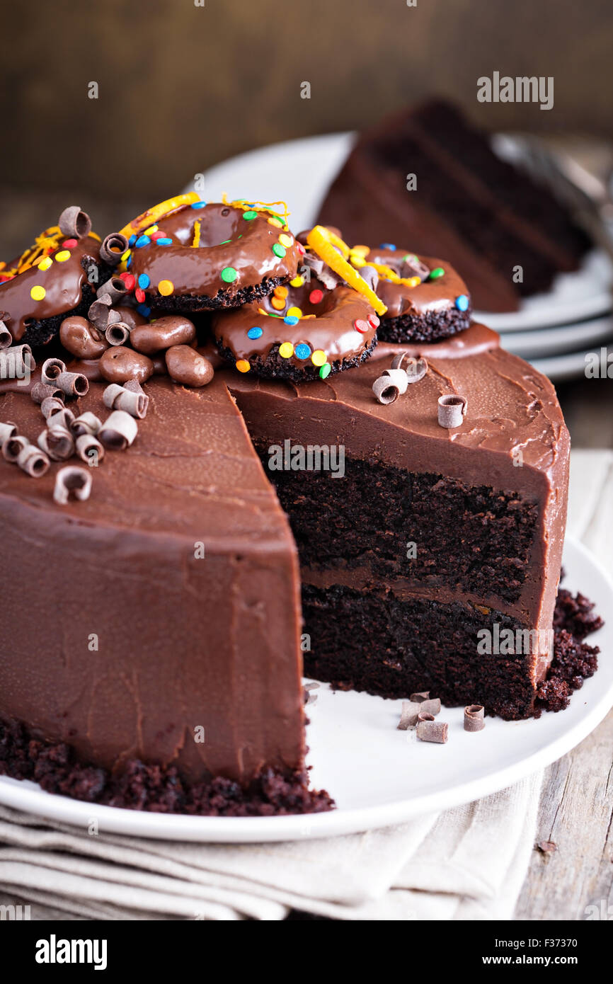 Dark Chocolate Orange Cake With Ganashe Frosting Decorated With Mini Donuts Stock Photo Alamy