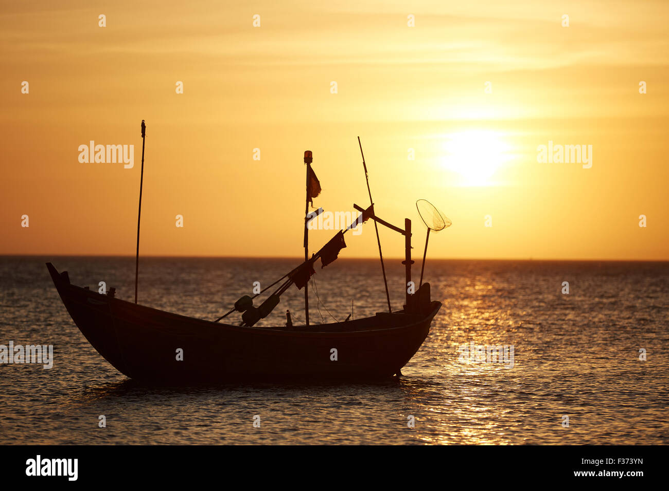 Fishing boats at sunset Stock Photo - Alamy