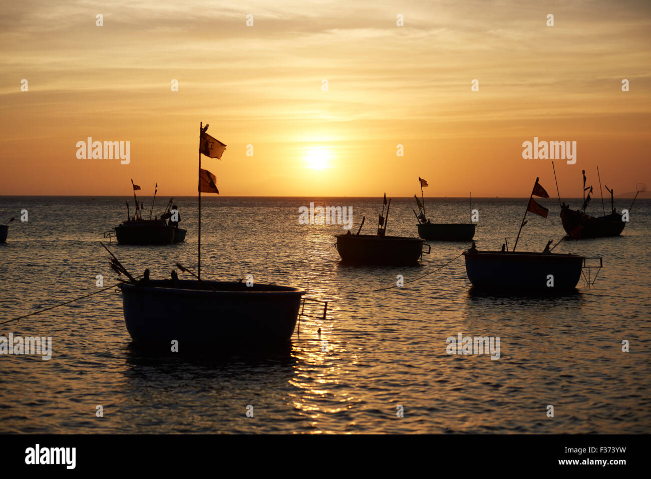 Fishing boats at sunset Stock Photo - Alamy
