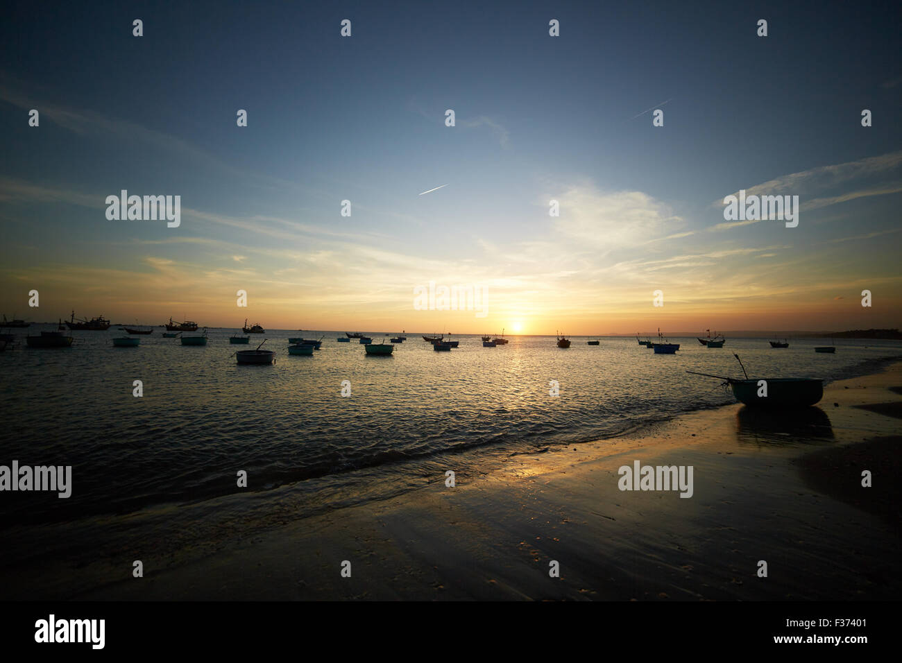 Fishing boats at sunset Stock Photo - Alamy