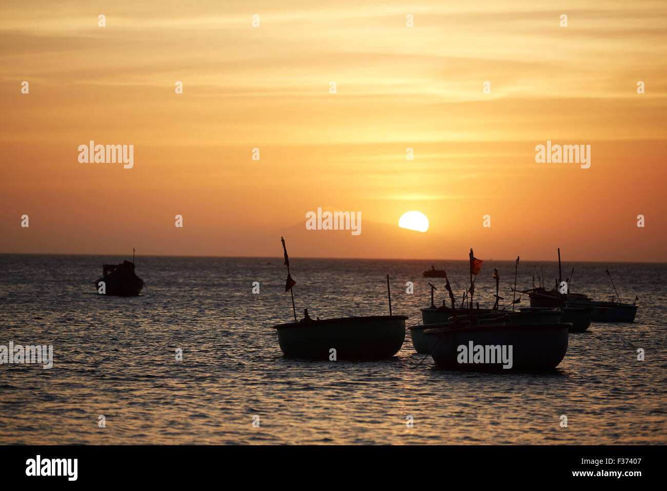Fishing boats at sunset Stock Photo - Alamy