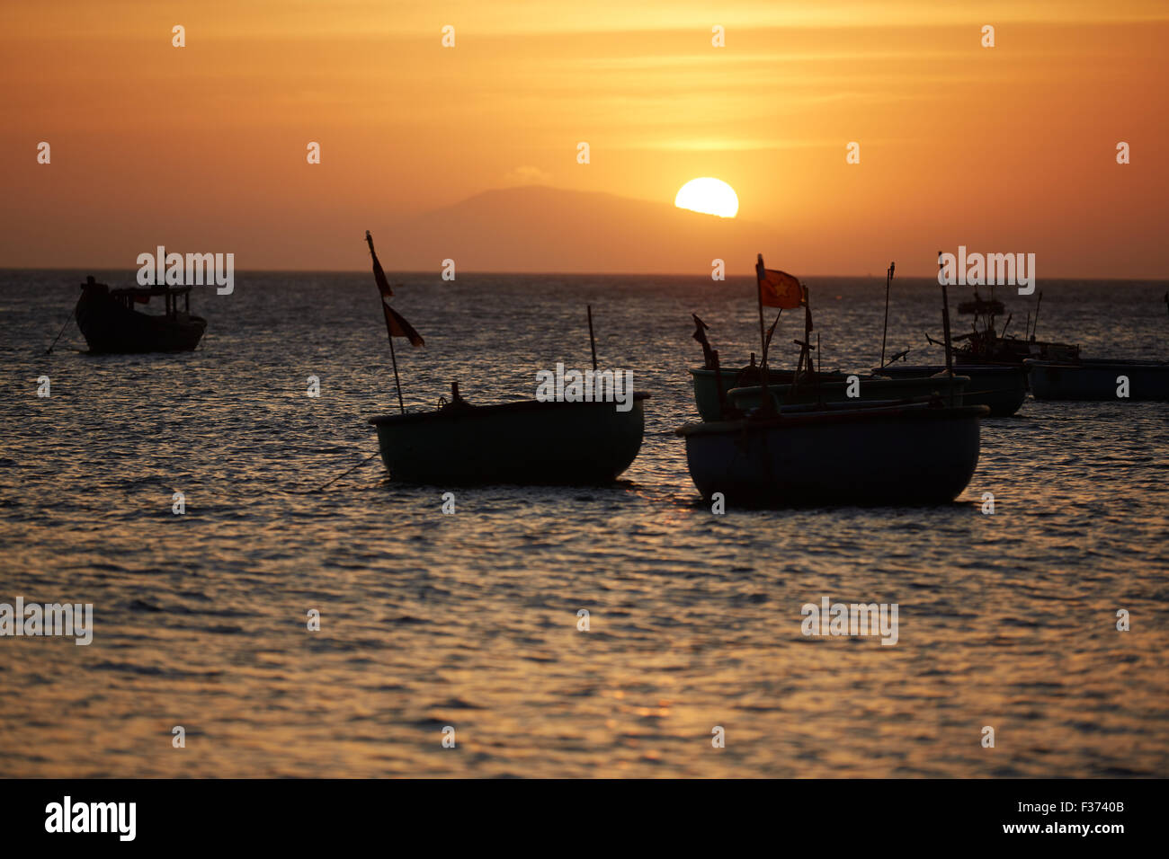 Fishing boats at sunset Stock Photo - Alamy