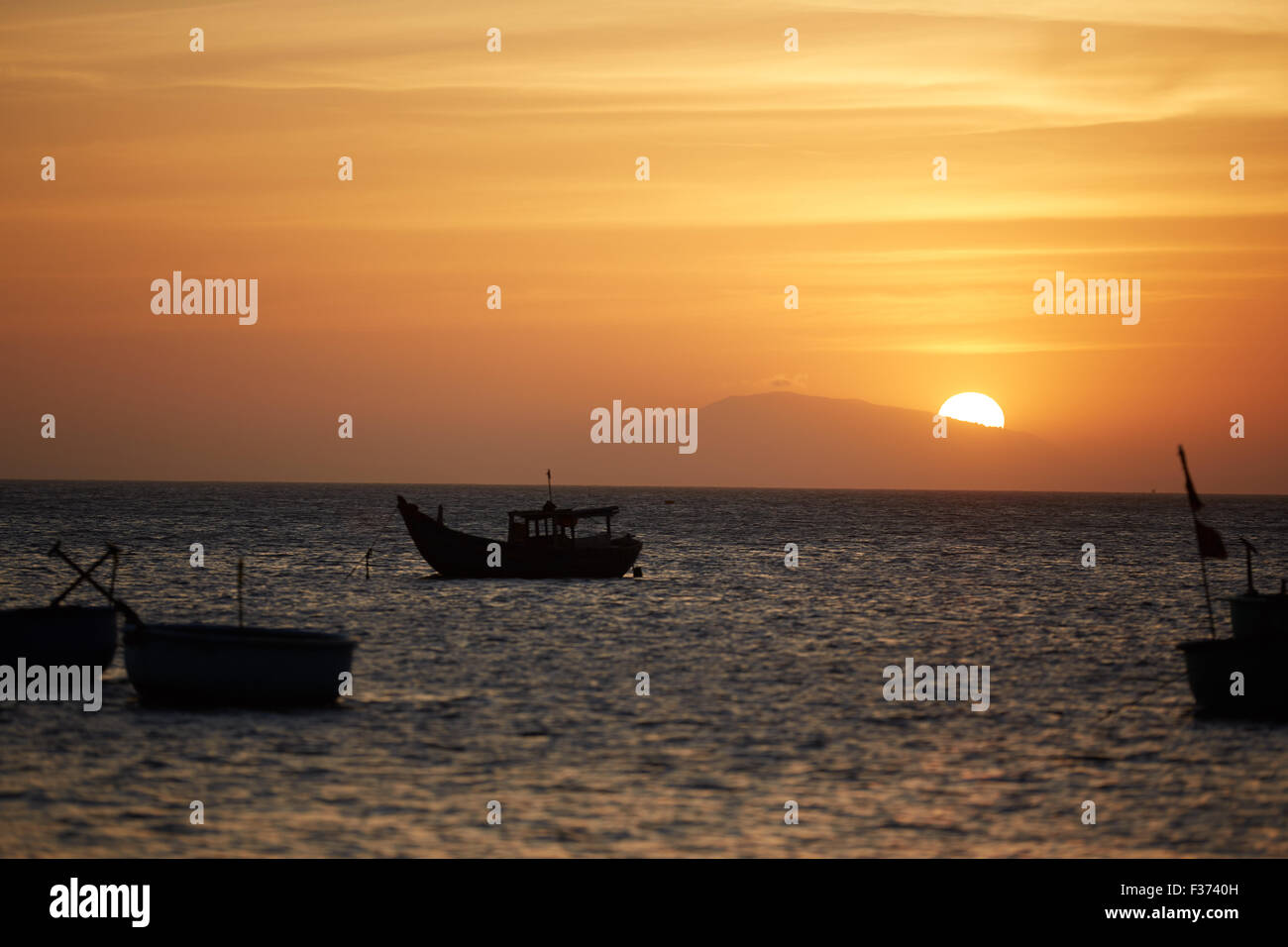 Fishing boats at sunset Stock Photo - Alamy