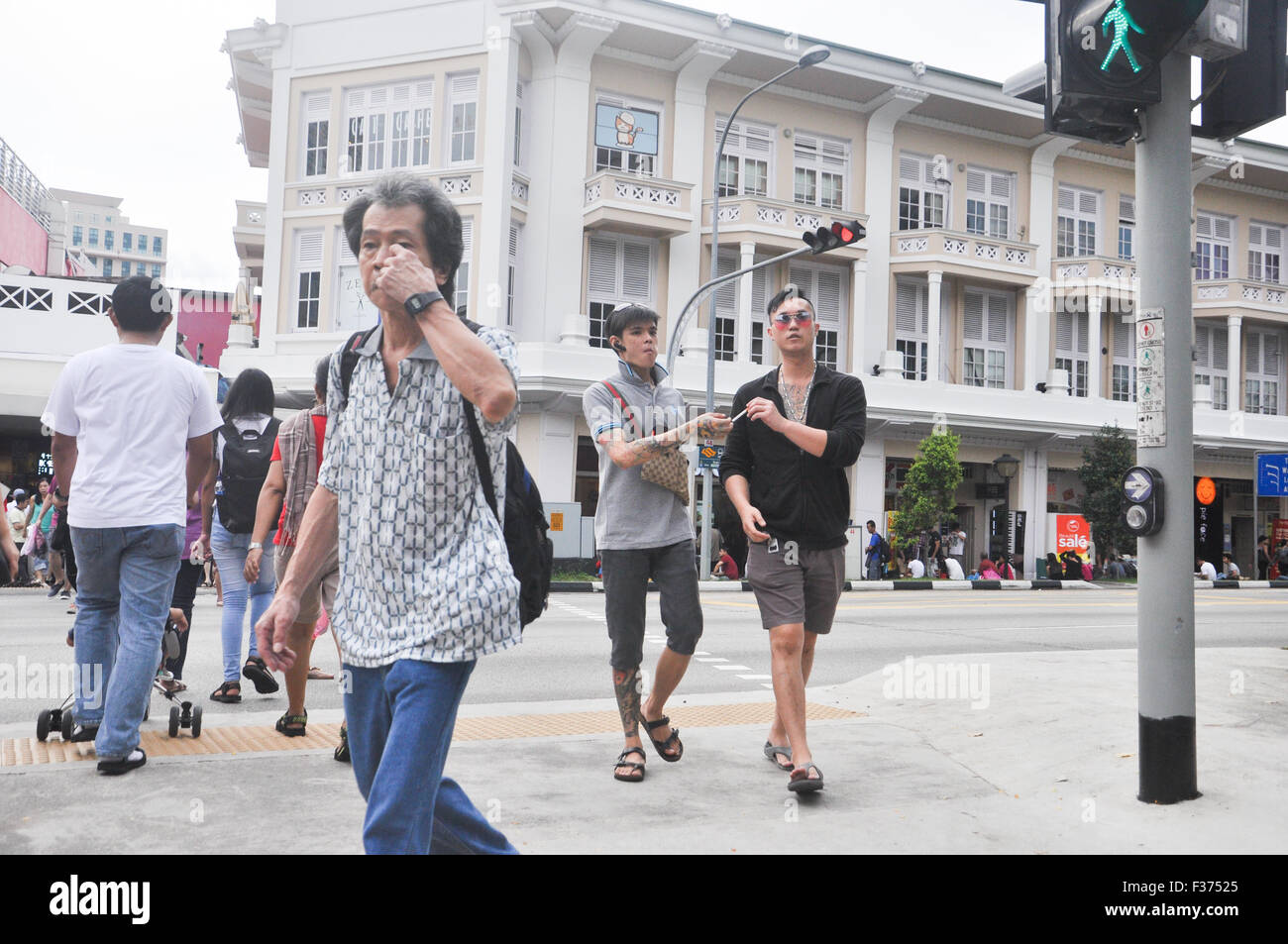 Singapore. People crossing the street at the traffic junction. Stock Photo