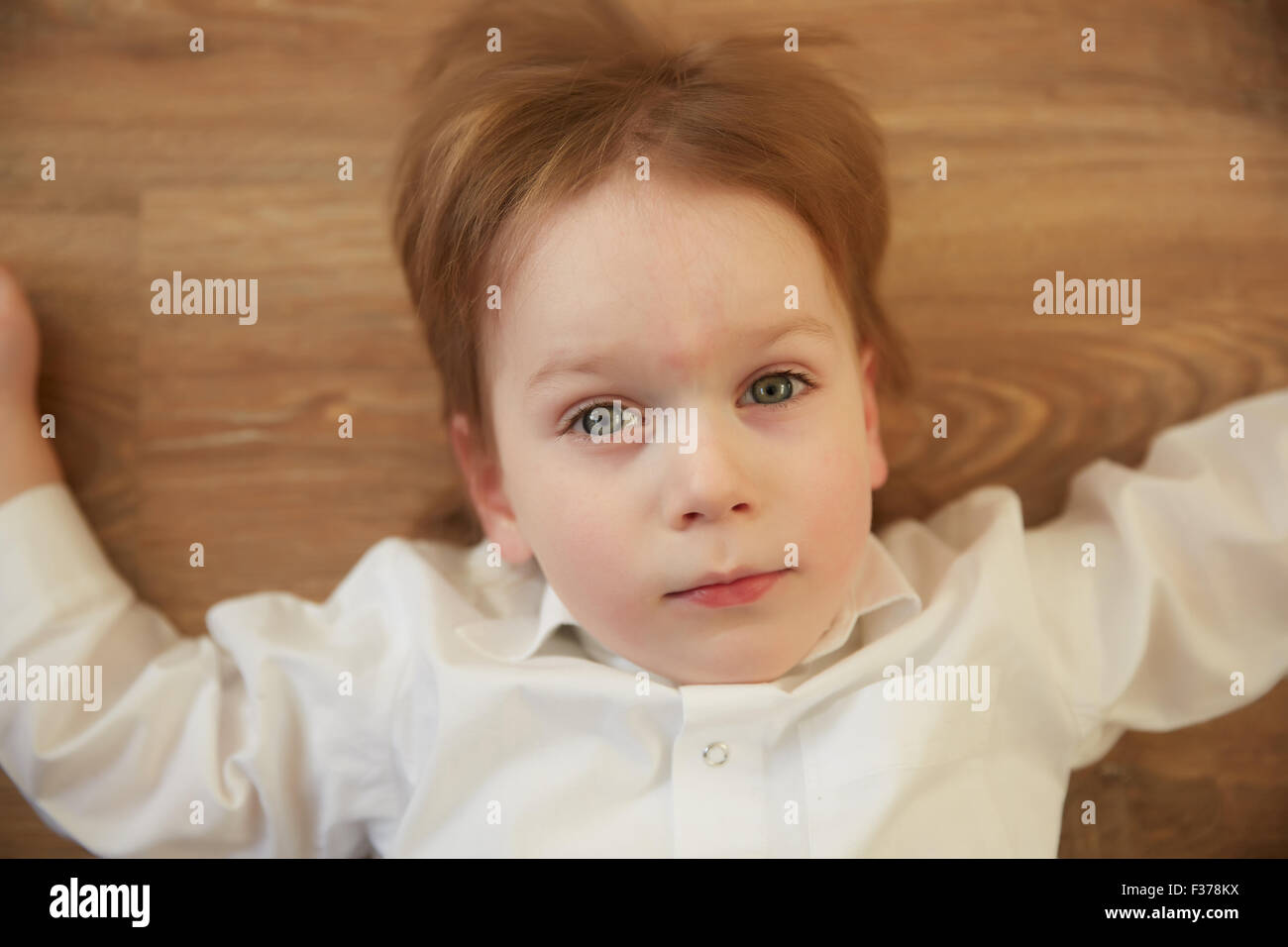 emotional cheerful boy lying on the floor Stock Photo Alamy