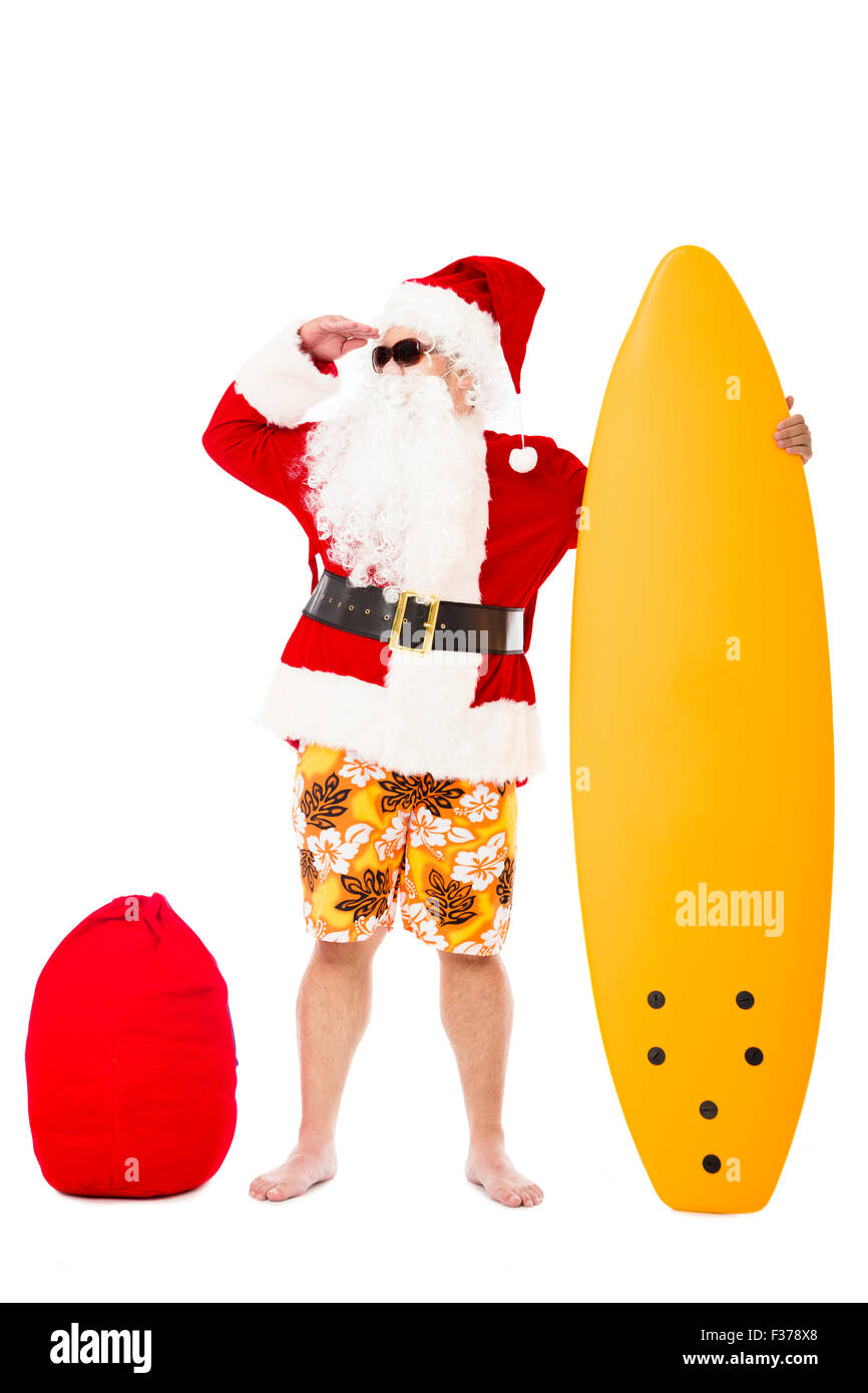 Happy Santa Claus standing with surf board Stock Photo