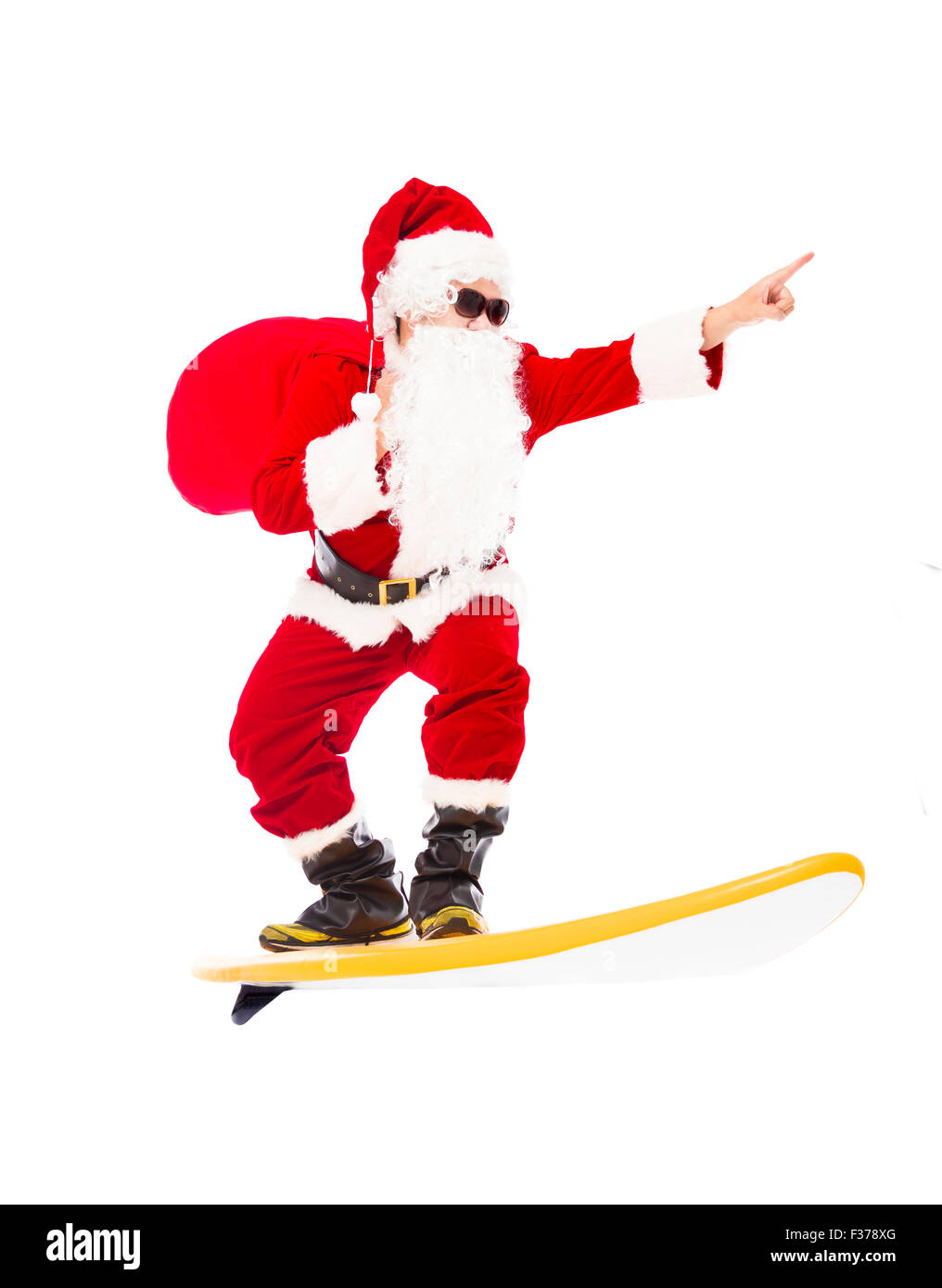 Happy Santa Claus surfing with surf board Stock Photo