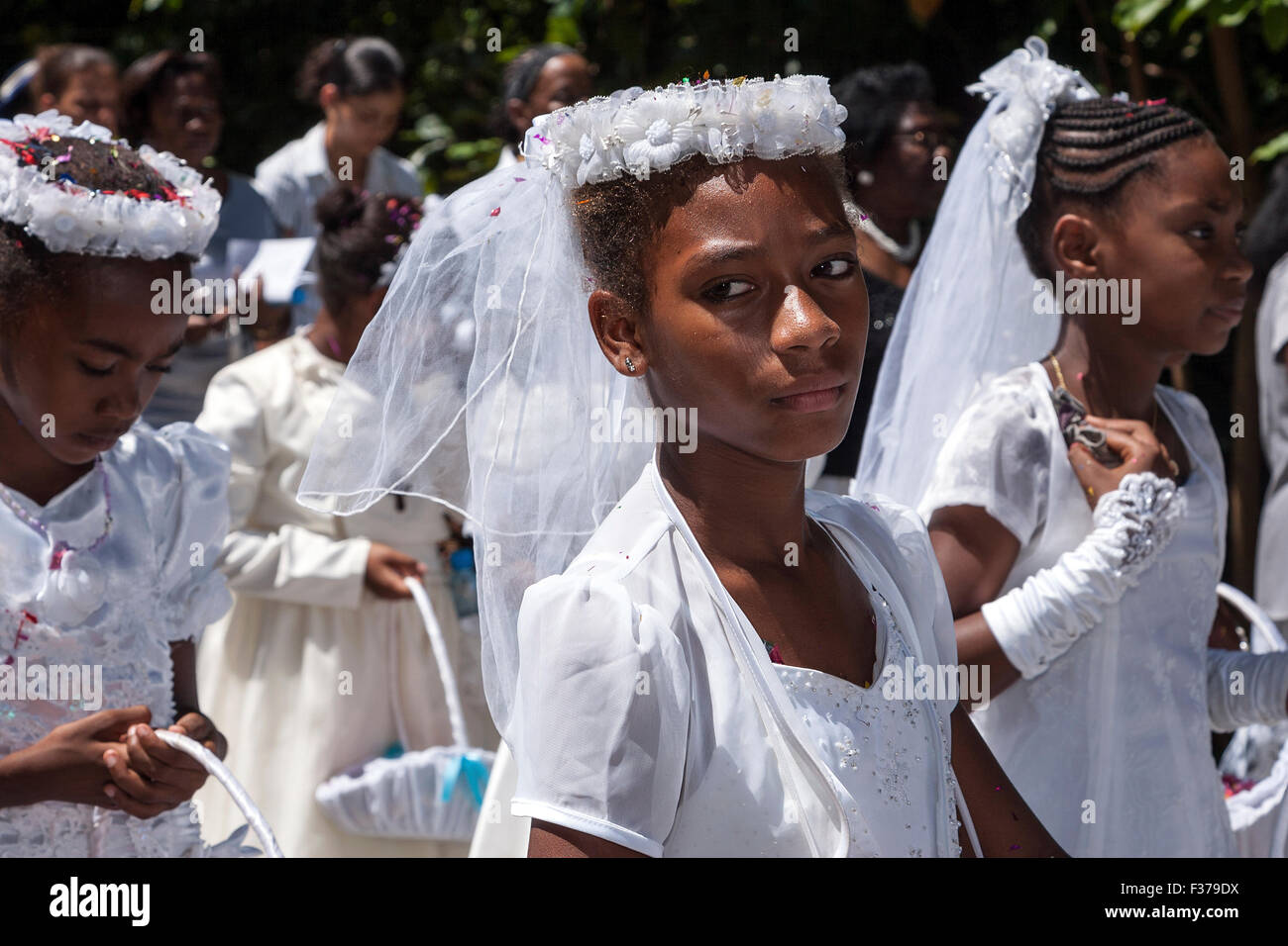 Girl dressed in white, festive clothing, Catholic festival, parade, procession on the holiday of the Assumption, La Digue Island Stock Photo
