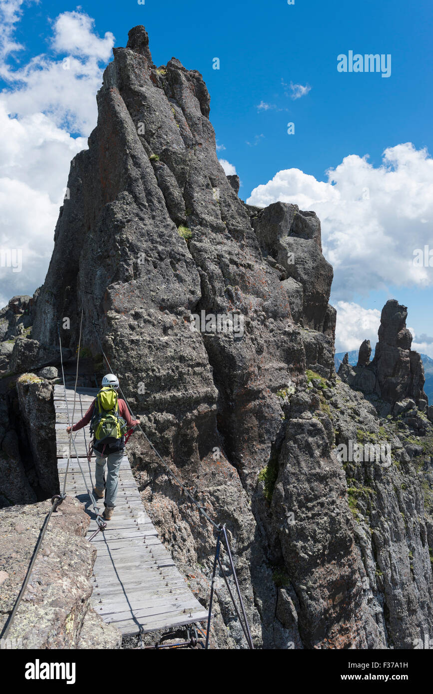 Woman crossing a rope bridge, Via Ferrata delle Trincee, Dolomites
