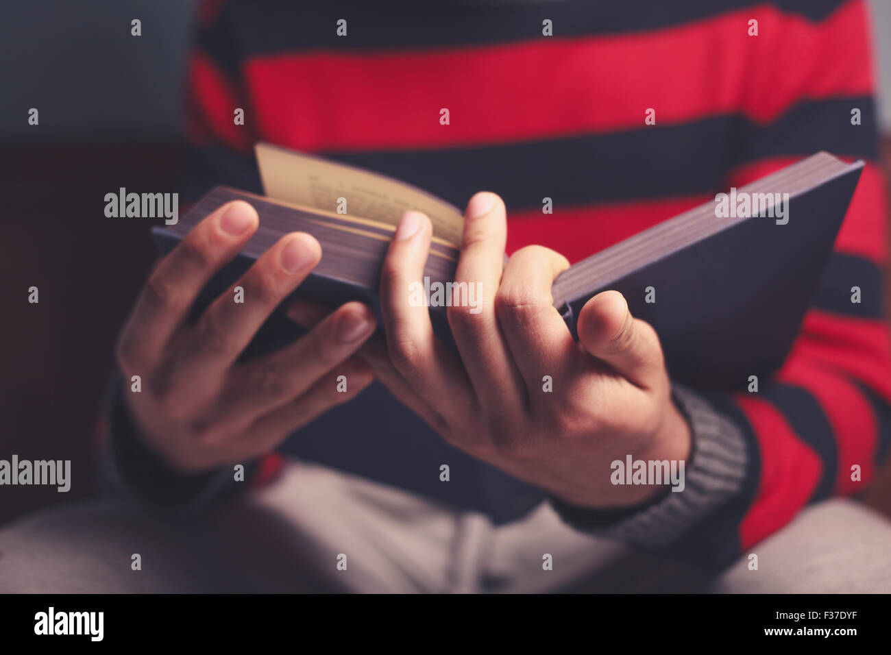 Closeup on a man reading a big heavy book Stock Photo Alamy