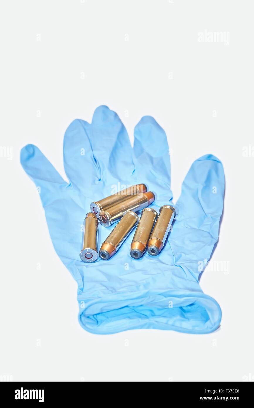 6x 357 Magnum Pistol Cartridges on Latex Gloves Stock Photo