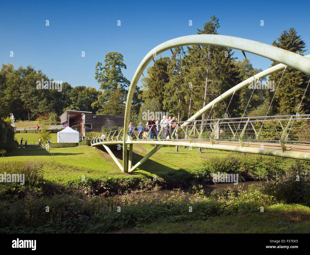 Entrance to Painshill Park Gardens, footbridge crossing the river Mole. Stock Photo