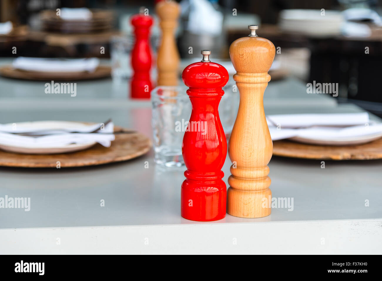 wooden salt and pepper mills on a dinner table Stock Photo Alamy