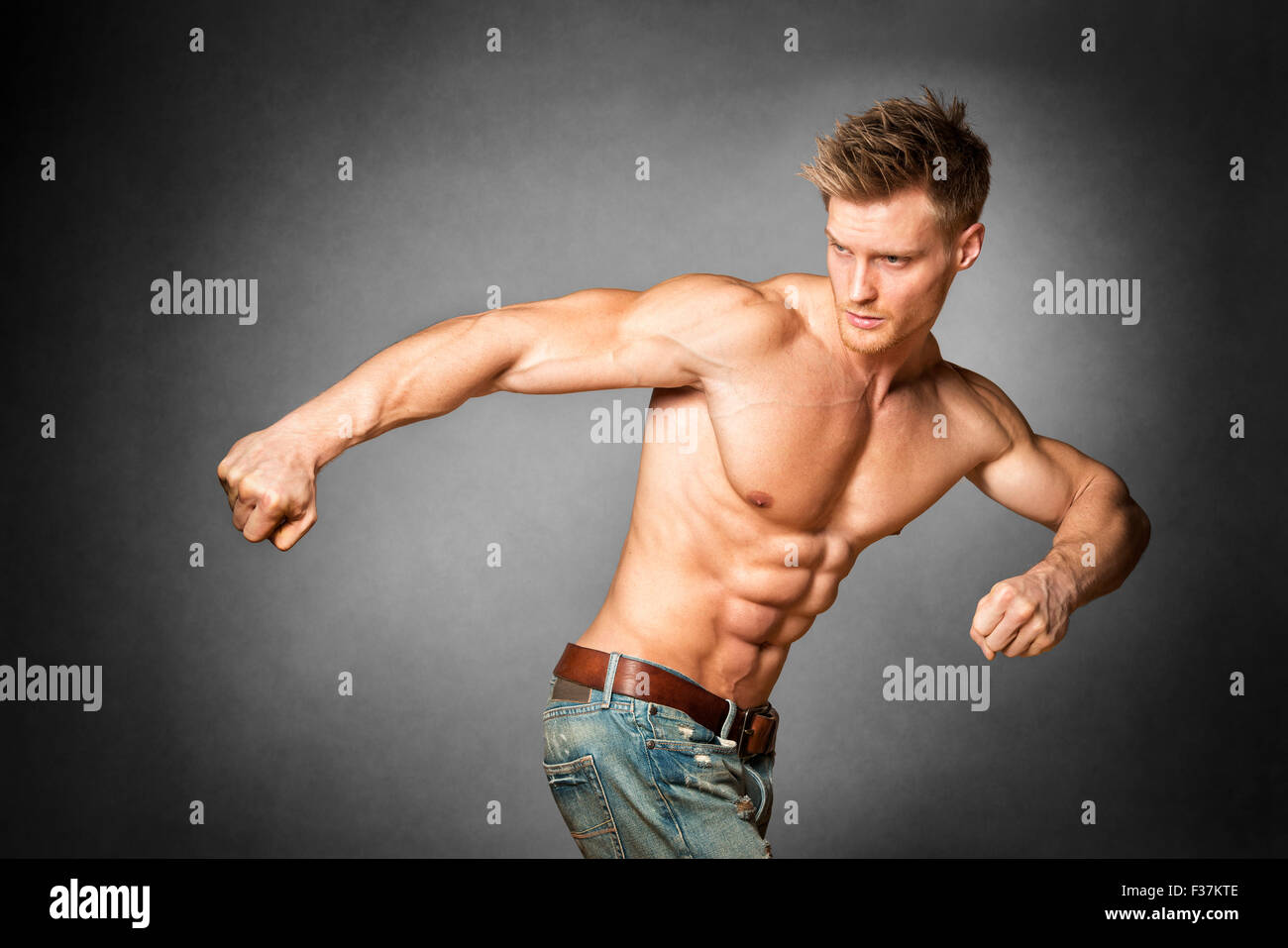 Handsome blond young man exercising pecs on gym equipment Fleece