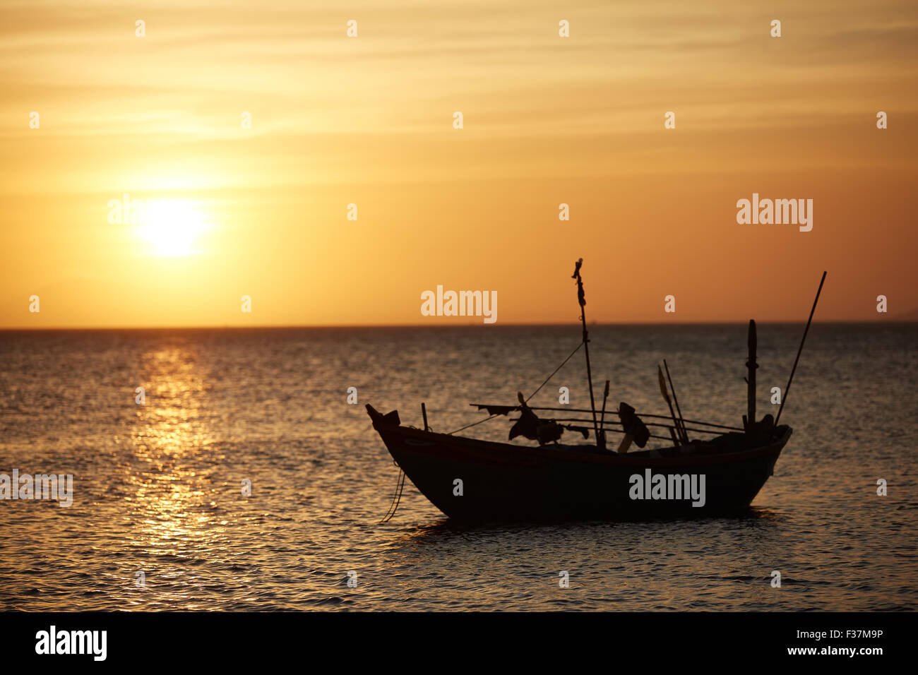 Fishing boats at sunset Stock Photo - Alamy