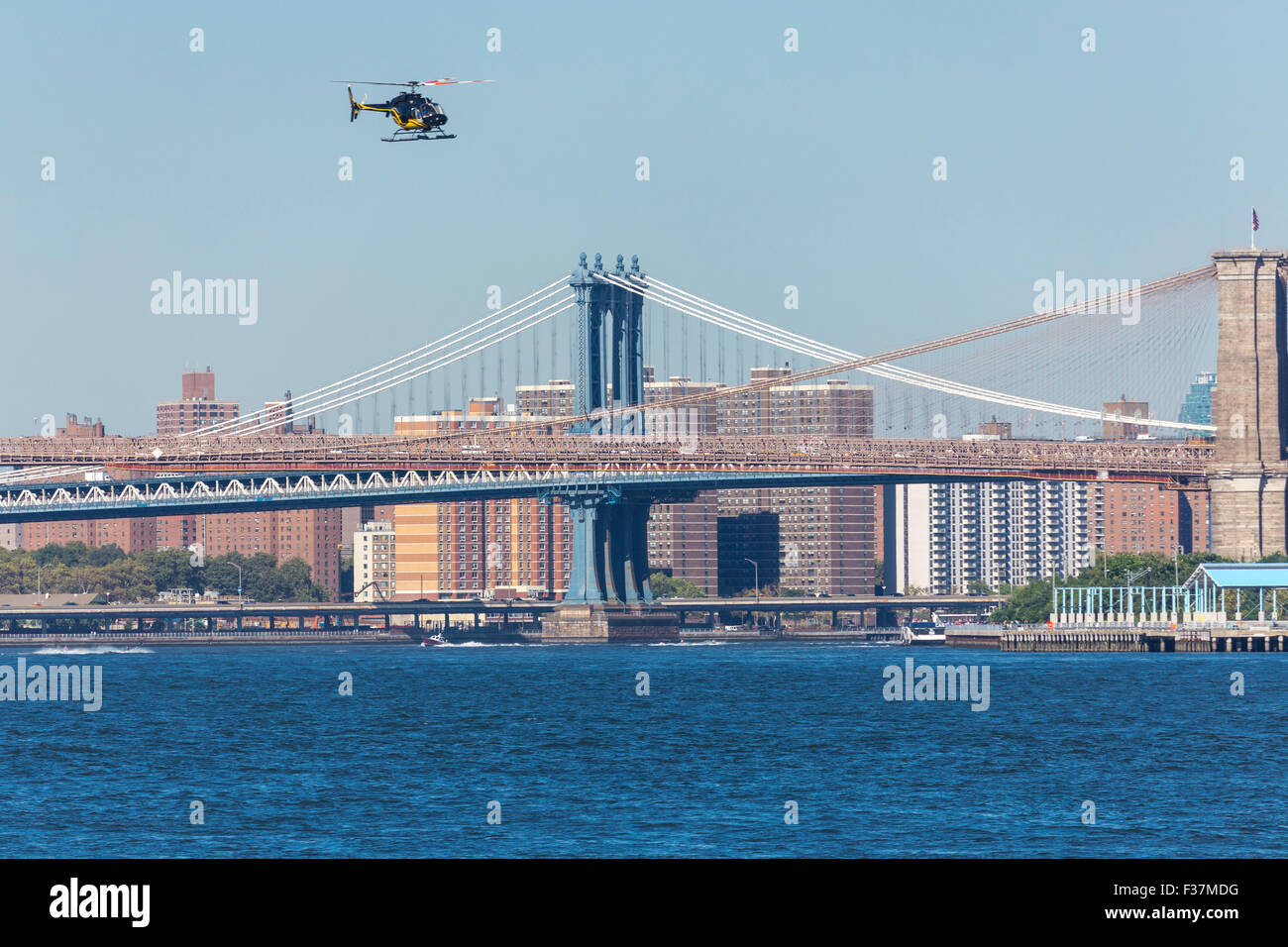 Sightseeing Helicopter over Manhattan and Brooklyn Bridges, East River, NYC, USA Stock Photo