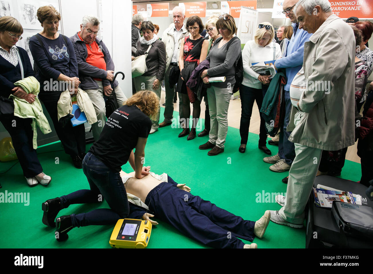 (151001) -- LJUBLJANA, Oct. 1, 2015 (Xinhua) -- A woman from the Ljubljana health centre demonstrates the use of a defibrillator and CPR at the 15th Festival for Third Age in Ljubljana, Slovenia, Sept. 30, 2015. The Festival for Third Age in Ljubljana, the largest of its kind in Europe, is a unique three-day event for the elderly, dedicated to active aging, the improvement of quality of life and solidarity among generations. It promotes cooperation among generations, the public, volunteers, societies, education and the government. The festival that takes place in Cankarjev dom Culture and Cong Stock Photo