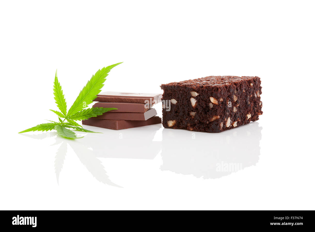 Cannabis chocolate and cannabis brownie with ganja leaf isolated on white background. Stock Photo