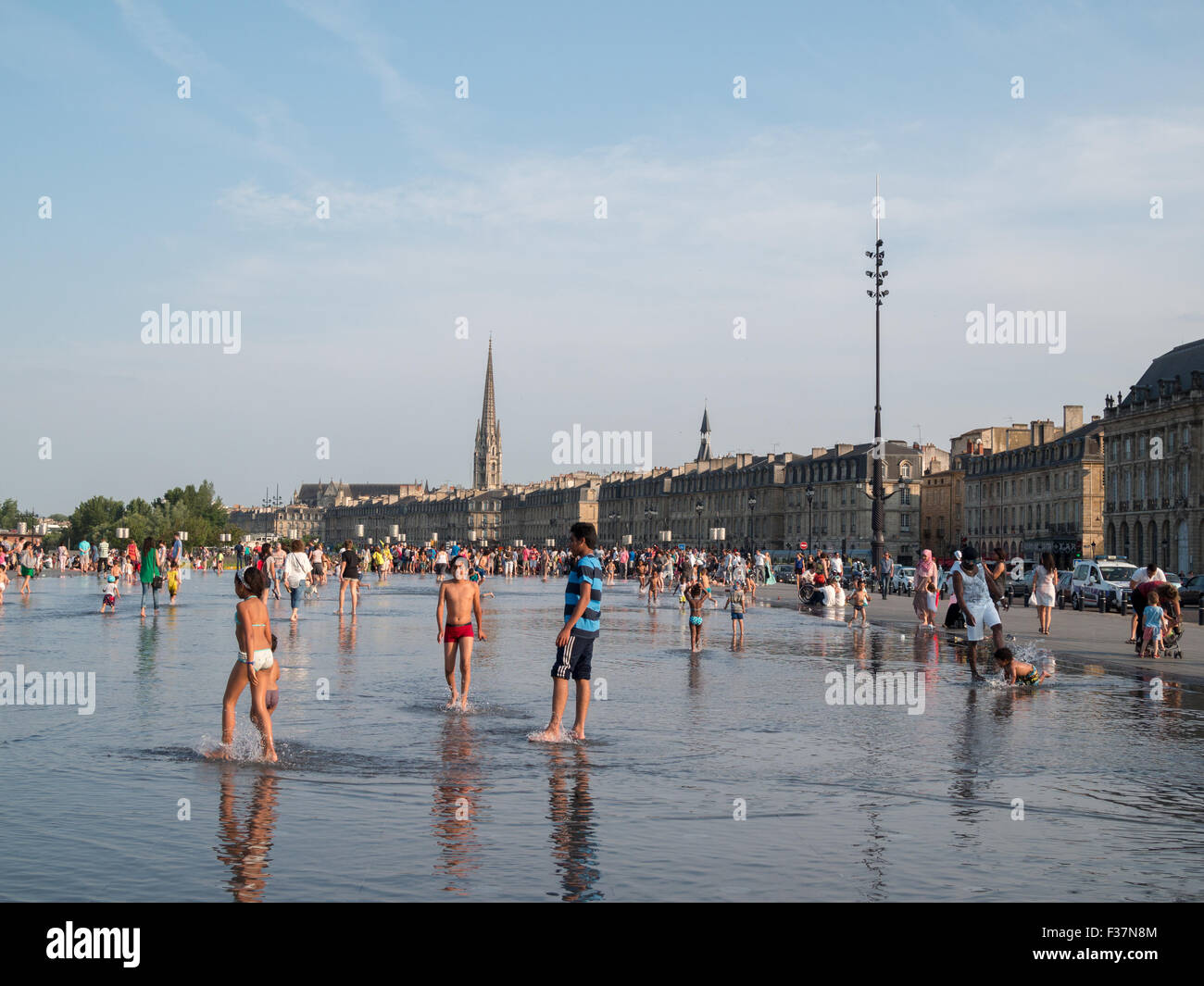 Children playing in the water at Le miroir d'eau Stock Photo