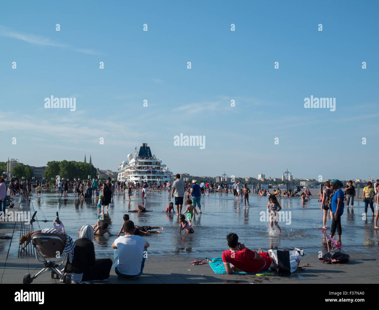 People playing and resting by Le miroir d'eau Stock Photo