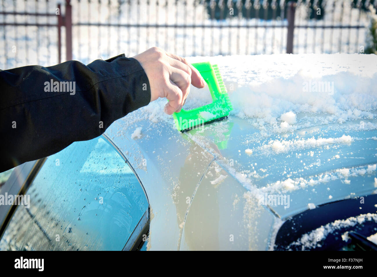 Winter and car. Person remove snow from car. Car covered with snow and