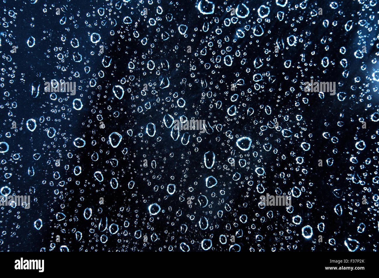 Blue water rain drops on the glass. Background picture Stock Photo - Alamy