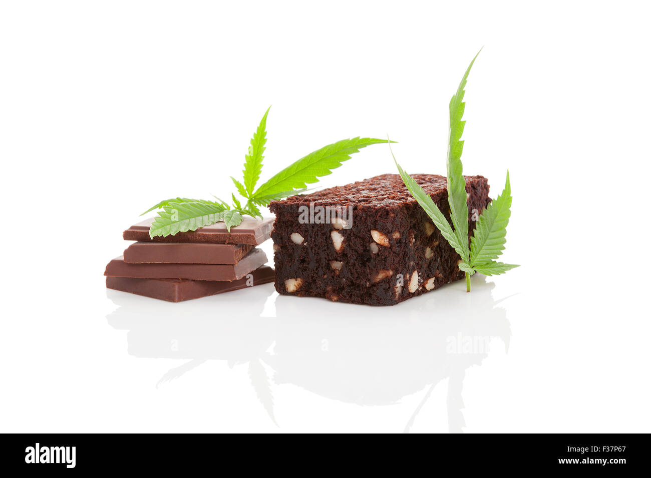 Cannabis chocolate and cannabis brownie with ganja leaf isolated on white background. Stock Photo