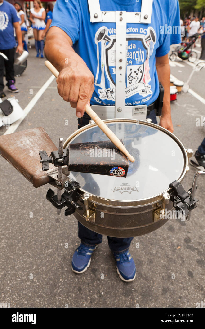 Man playing treble drum and cowbell - USA Stock Photo