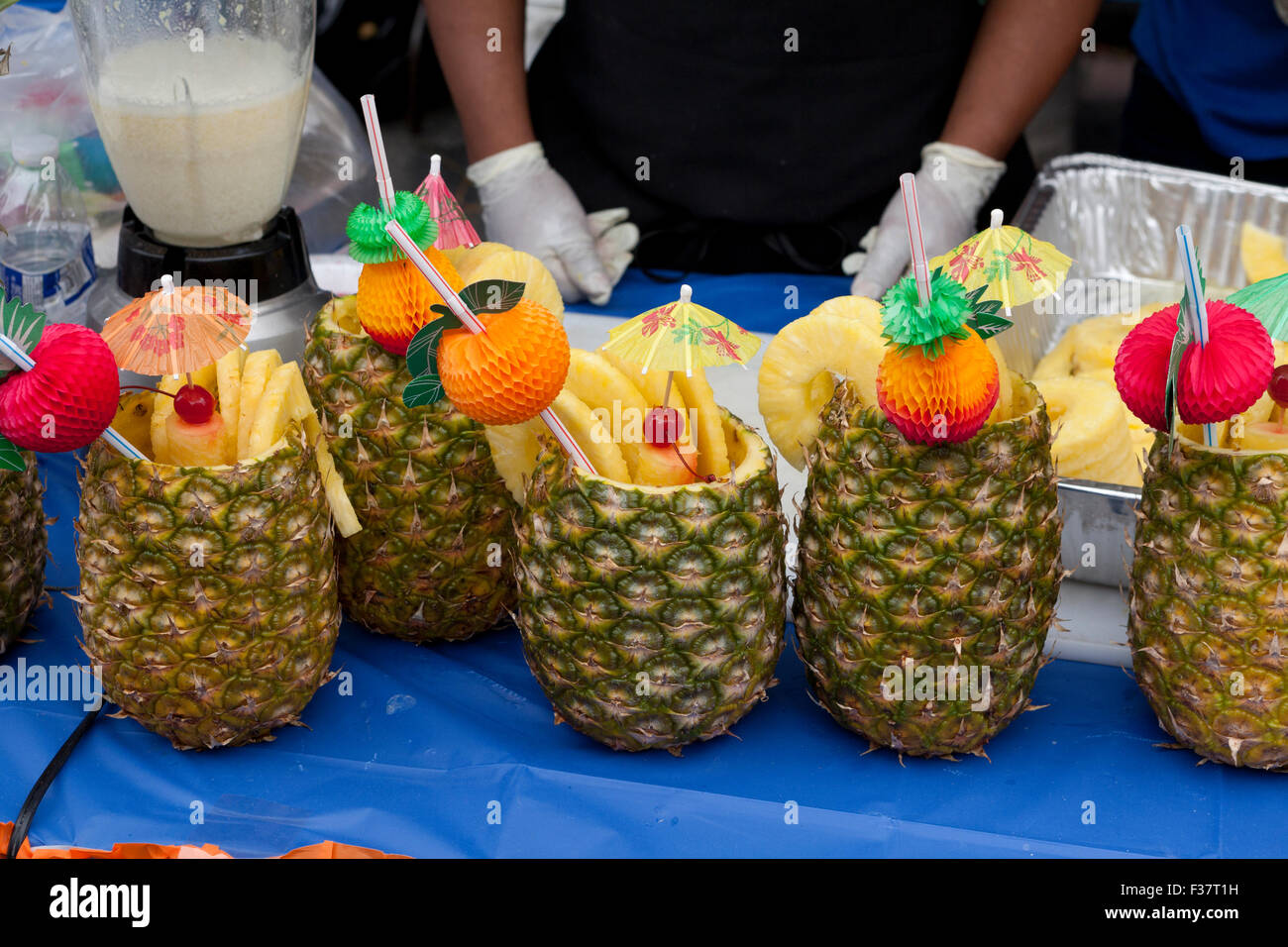 Piña Colada cocktail in pineapple at outdoor festival - USA Stock Photo