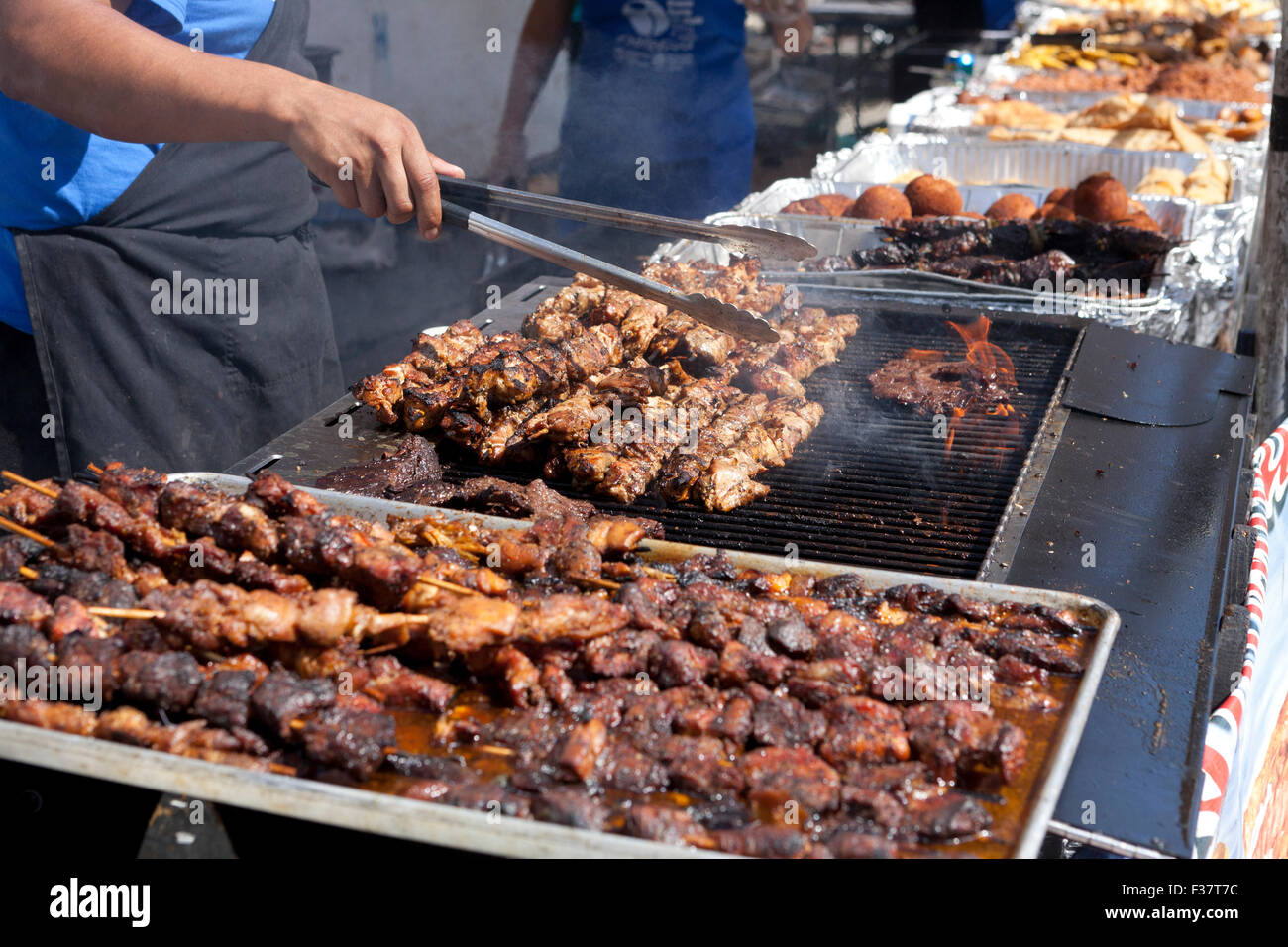 Man grilling barbecue chicken skewers USA Stock Photo Alamy