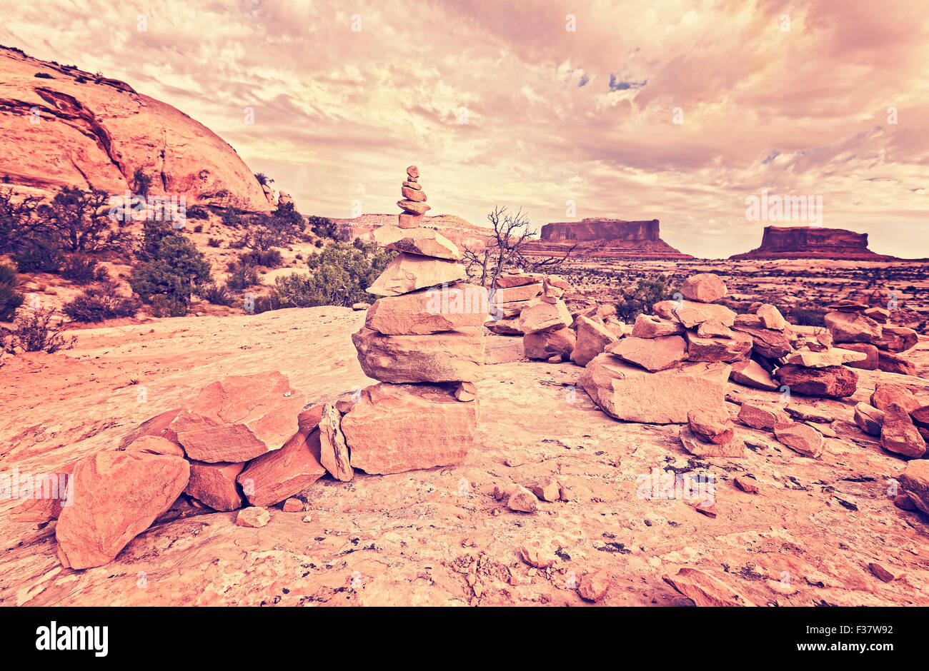 Retro stylized trail stone footpath mark in Canyonlands National Park, Island in the Sky district, Utah, USA. Stock Photo