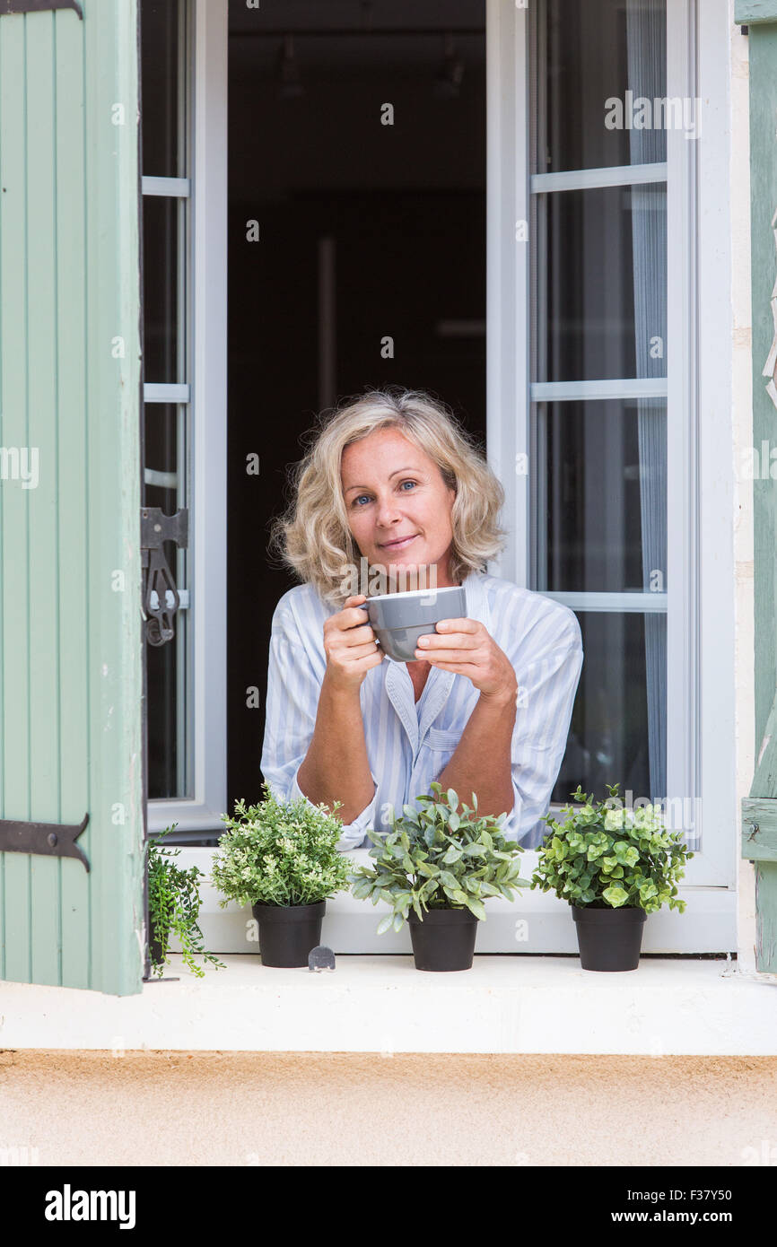 Woman drinking a hot beverage. Stock Photo