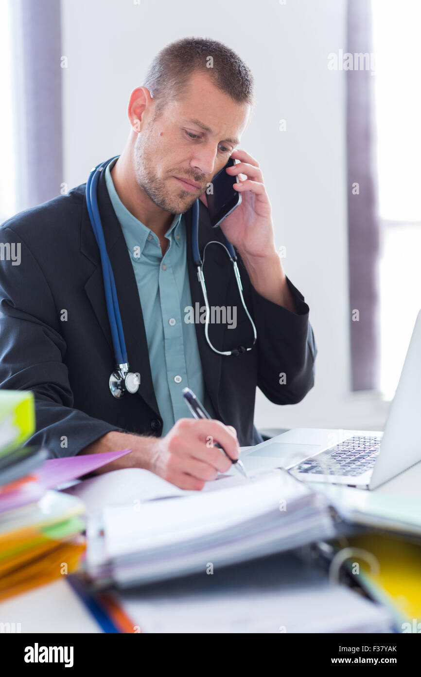 General practitioner dealing with accounting and administrative work. Stock Photo