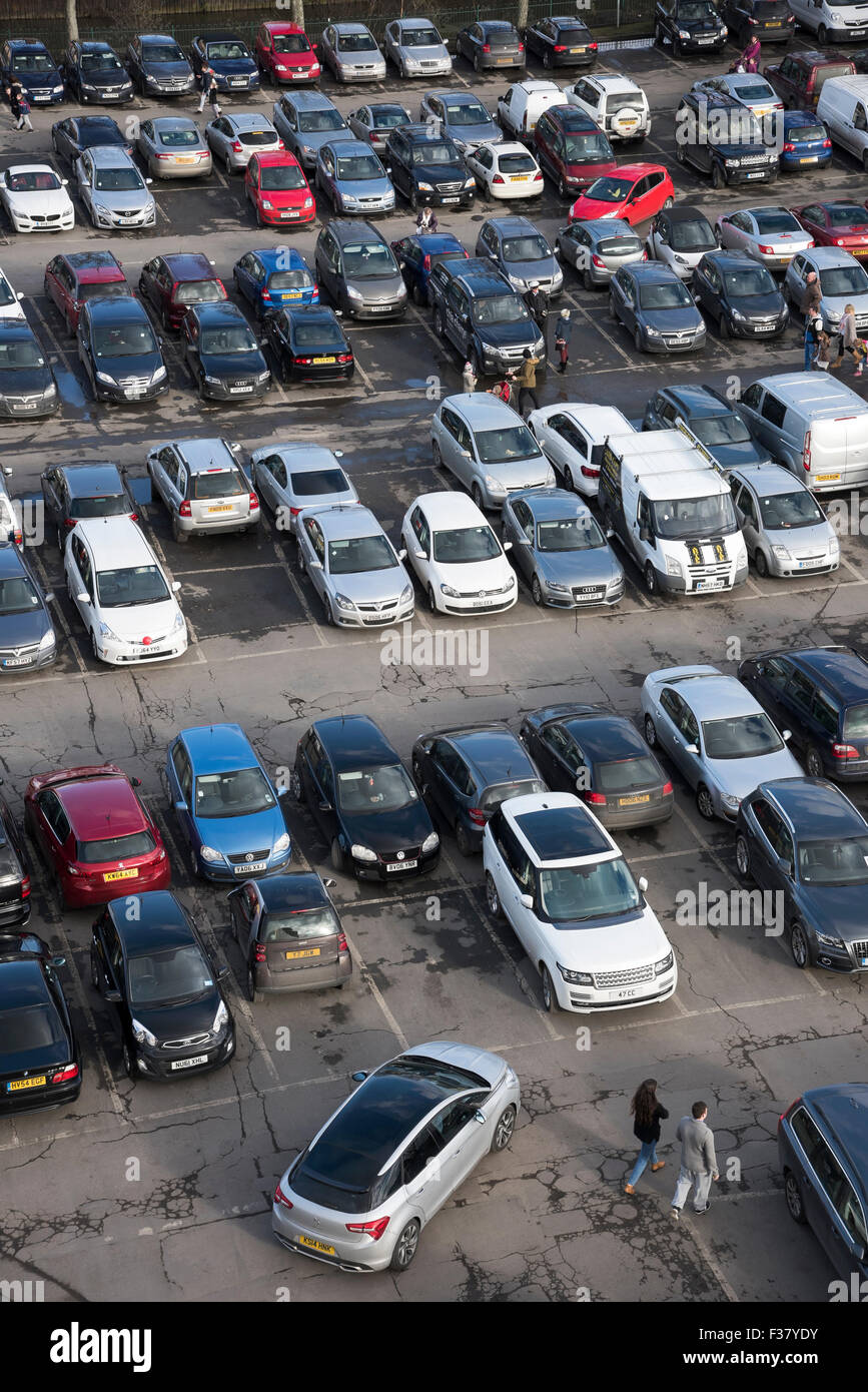 High view from Clifford's Tower - people walking, cars driving, manoeuvring or parked, in a busy, crowded Castle car park, York, North Yorkshire, UK.l Stock Photo