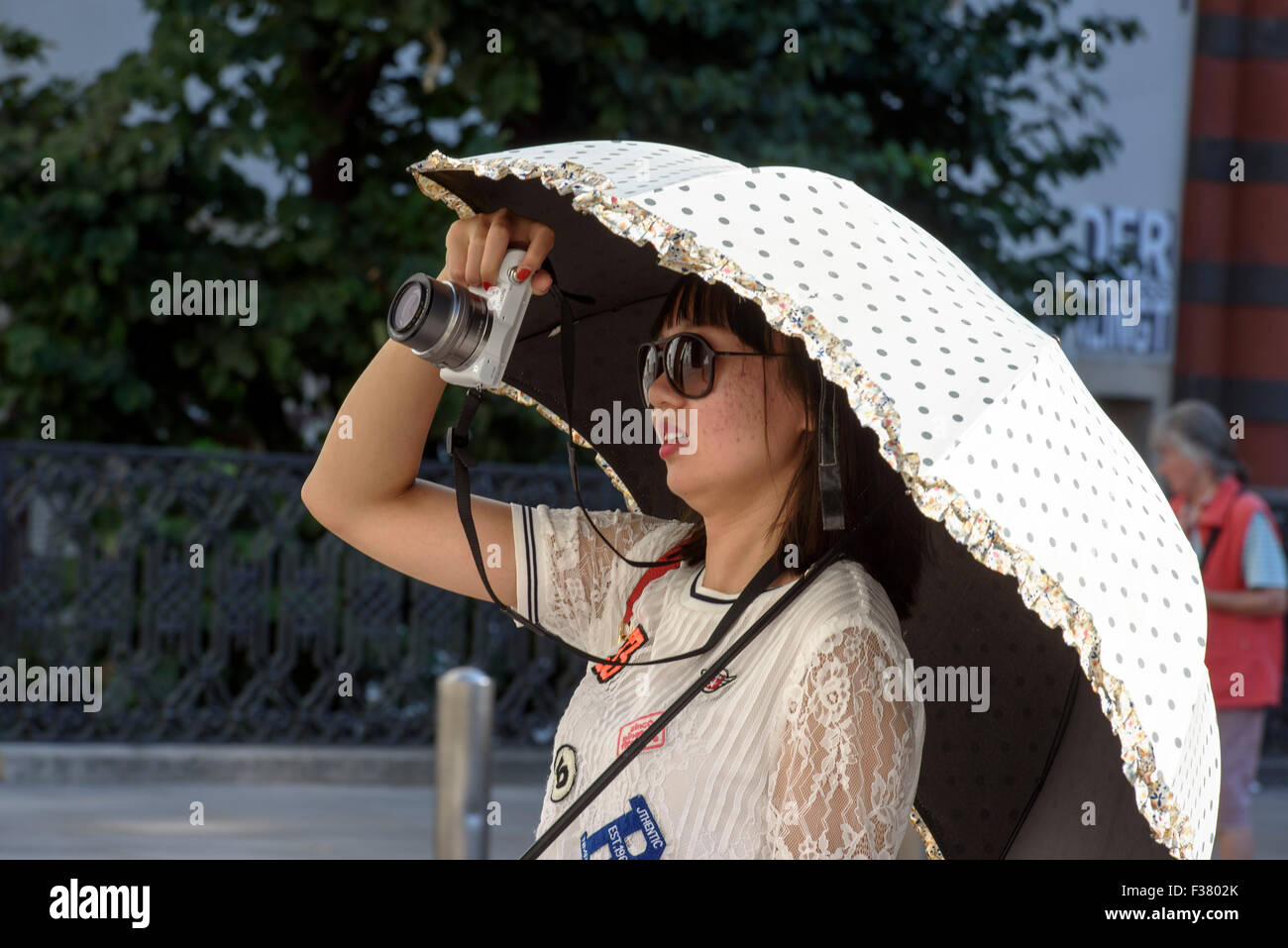 Tourist with parasol taking pictures, Vienna, Austria Stock Photo