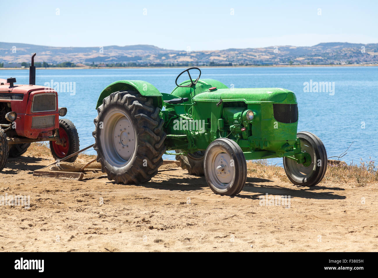Very old green tractor in field Stock Photo