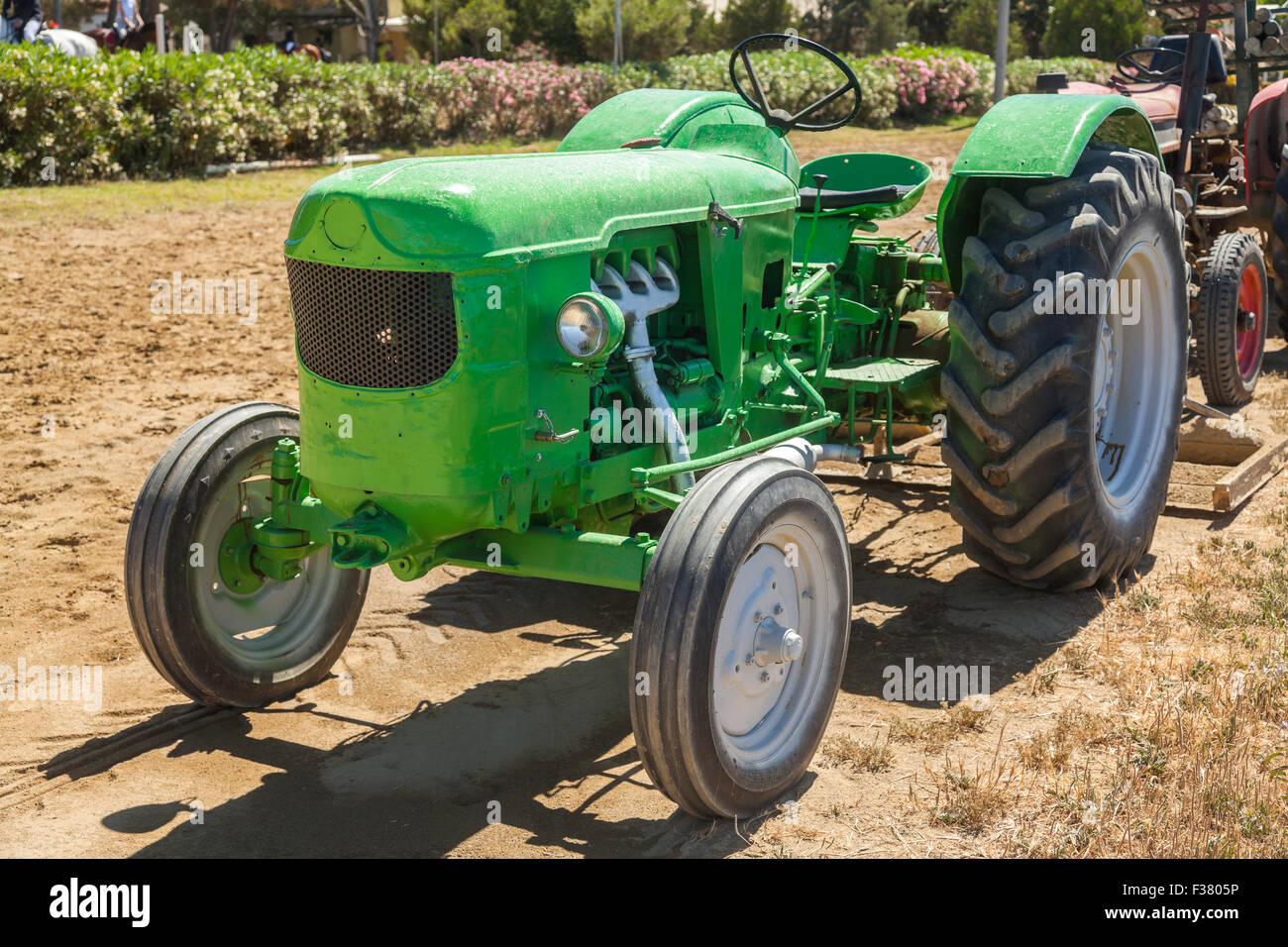 Very old green tractor in field Stock Photo