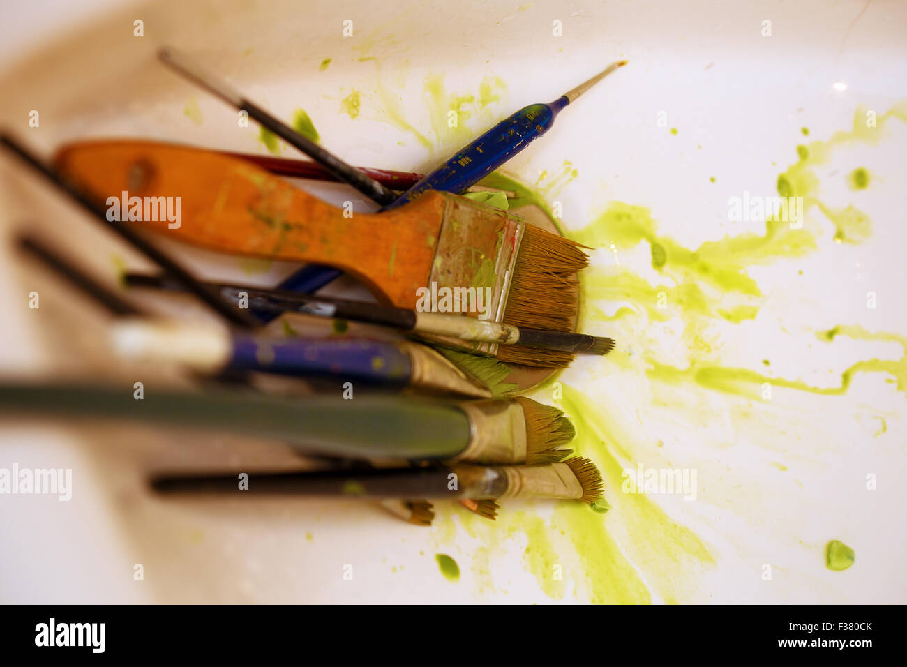 Cleaning Paint brushes in the sink by color Stock Photo Alamy