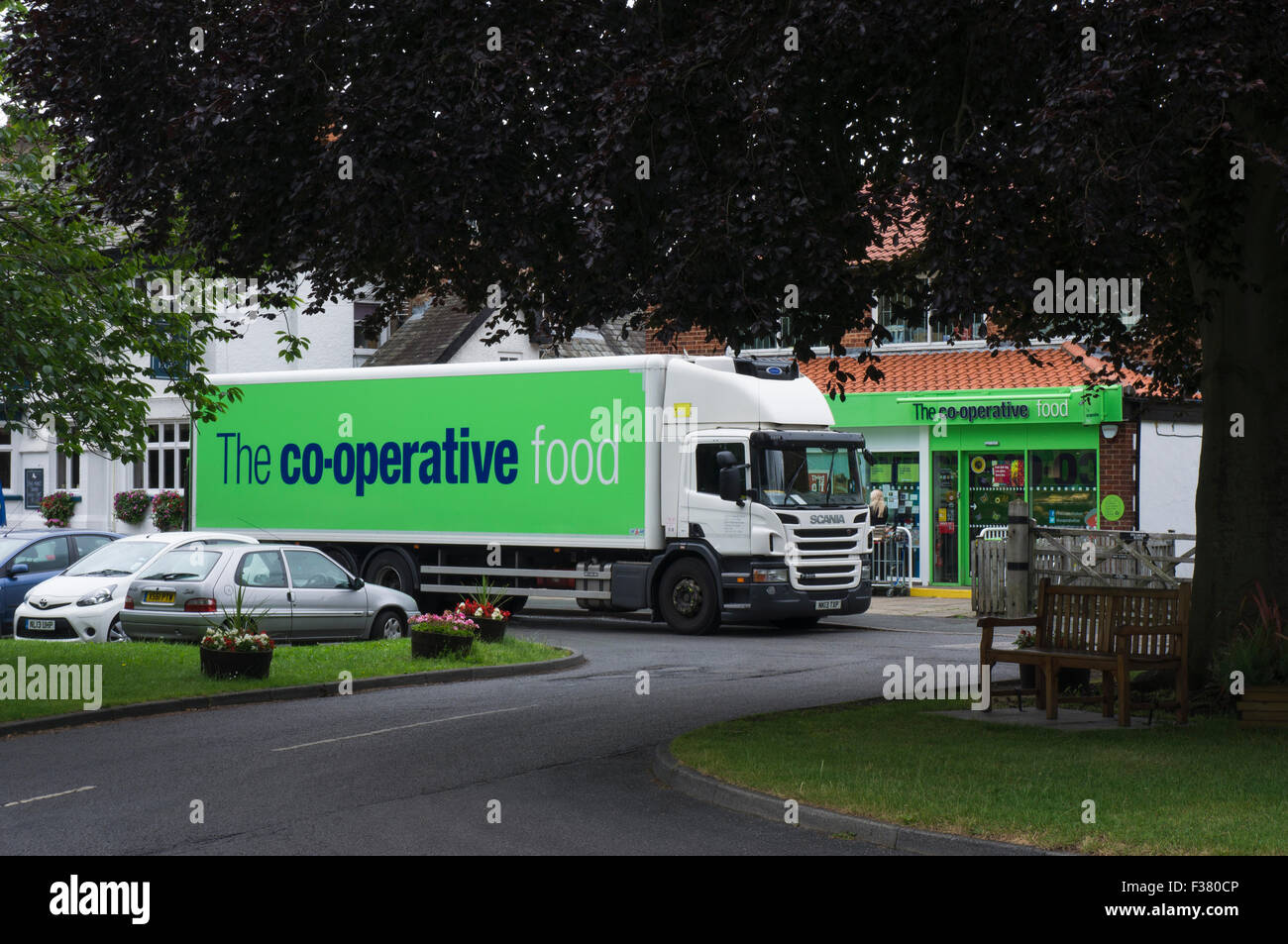 Delivering shop goods, a green and white, CoOperative Food lorry is