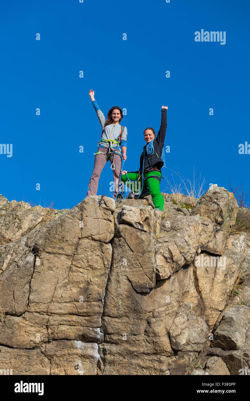 Group of two happy female climbers that are just conquered the summit