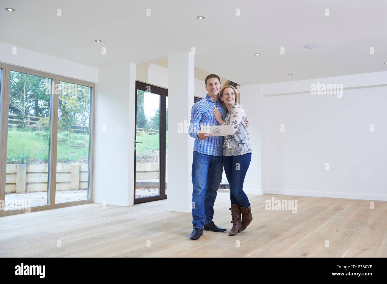 Happy Young Couple Looking At Details Of New Home Stock Photo