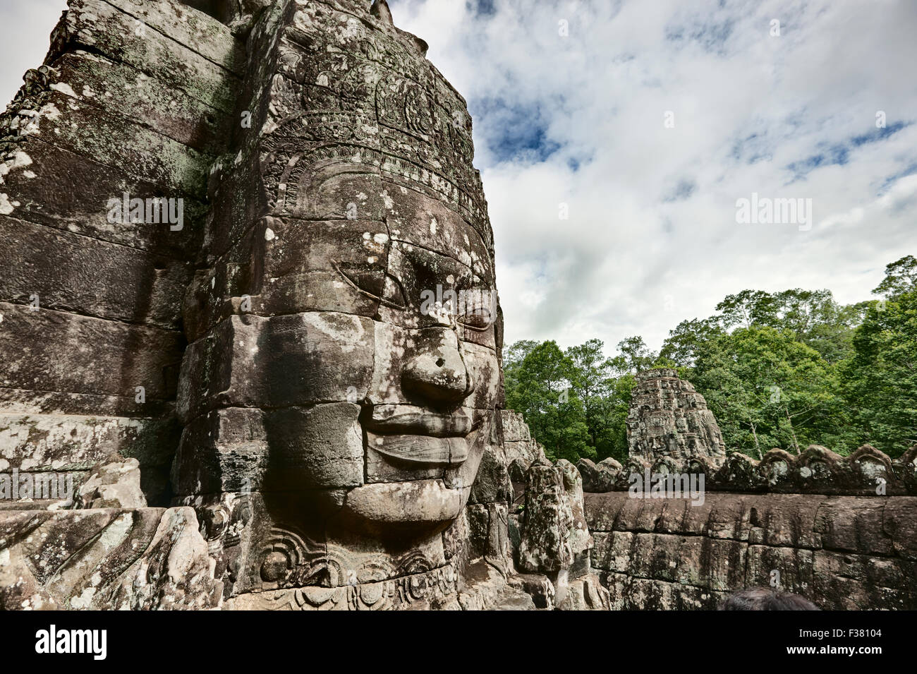 Carved stone giant face at Bayon temple in Angkor Thom. Angkor Archaeological Park, Siem Reap Province, Cambodia. Stock Photo