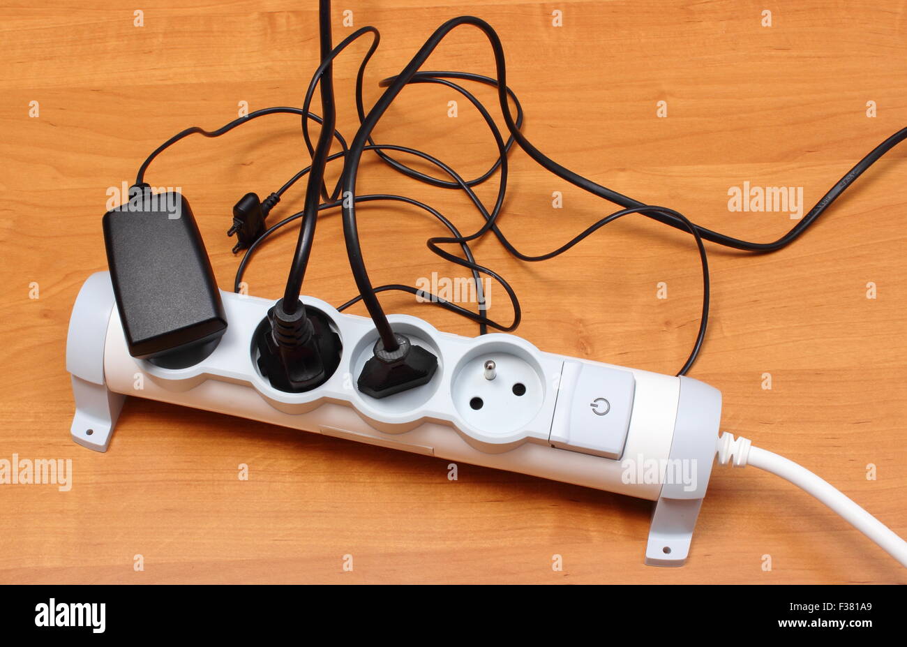 Electrical plugs with cords connected to electrical power strip ...