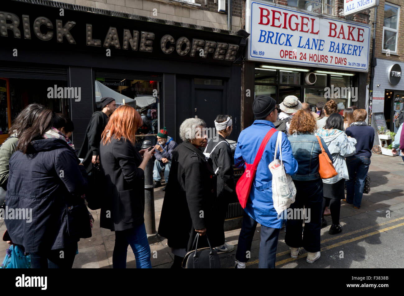 People queuing at Beigel Bake shop in Brick Lane London E1 Stock Photo