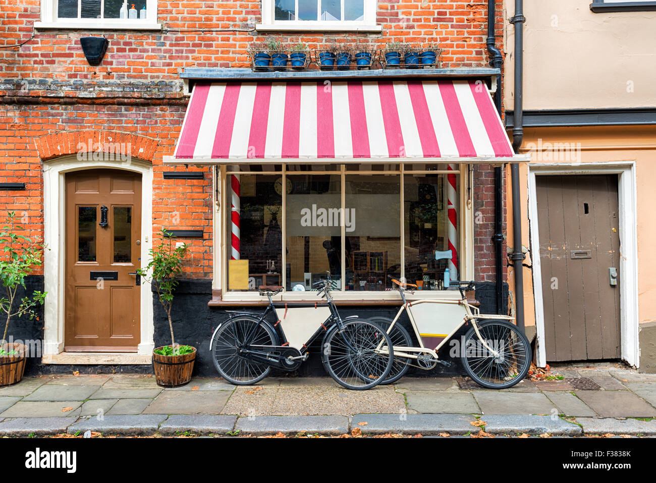 A traditional barber shop with bicycles outside Stock Photo