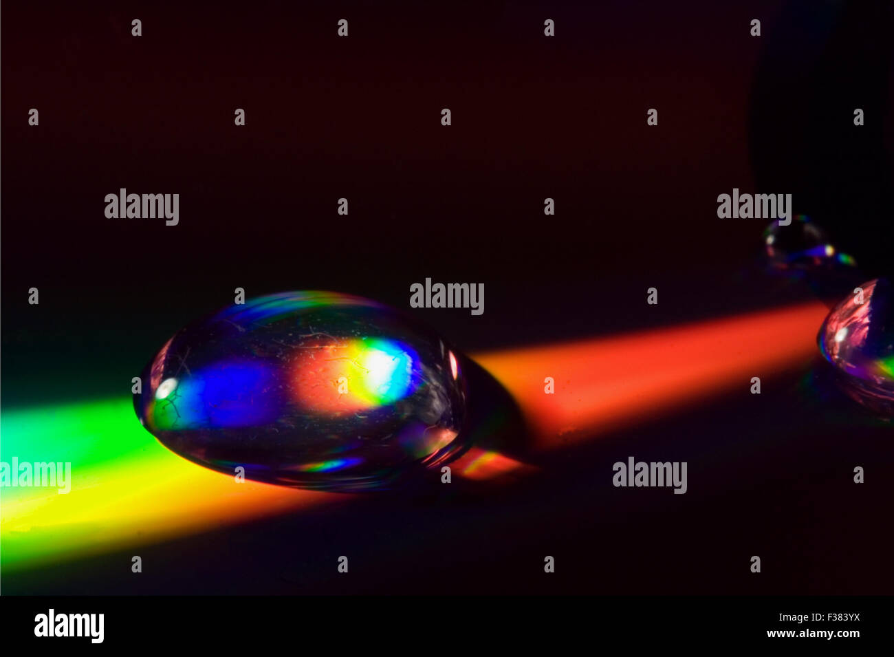 rainbow drop in a plastic cd material abstract Stock Photo - Alamy