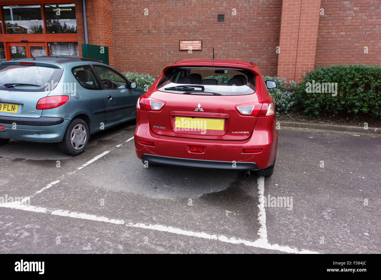 Inconsiderate parking in a car park, UK. Stock Photo