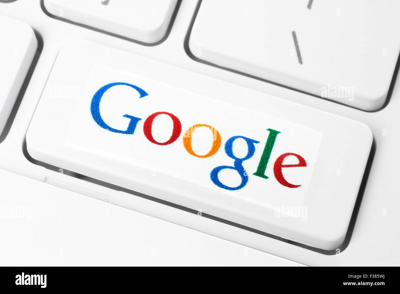 KIEV, UKRAINE - JANUARY 10, 2015: Keyboard with Google logotype, printed on paper and placed on button. Stock Photo
